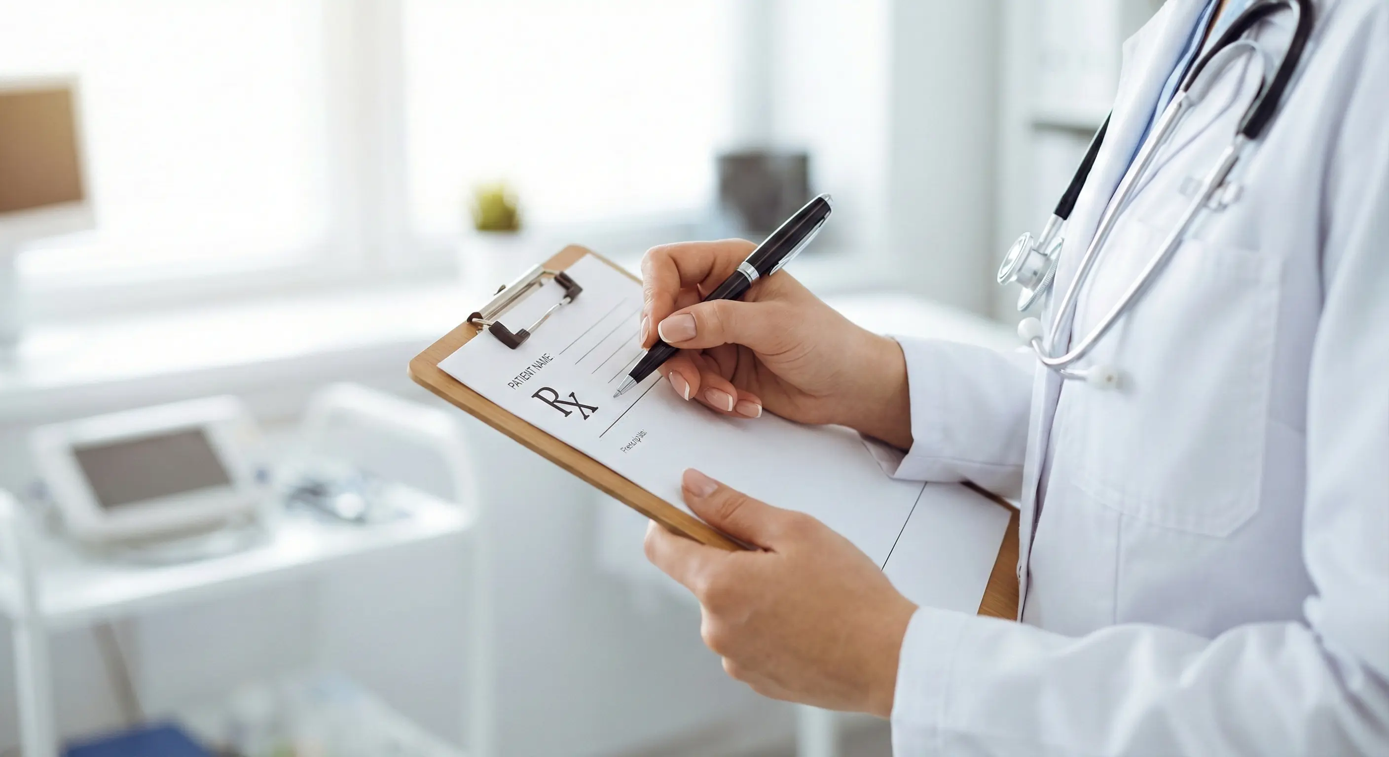 Doctor writing on a clipboard